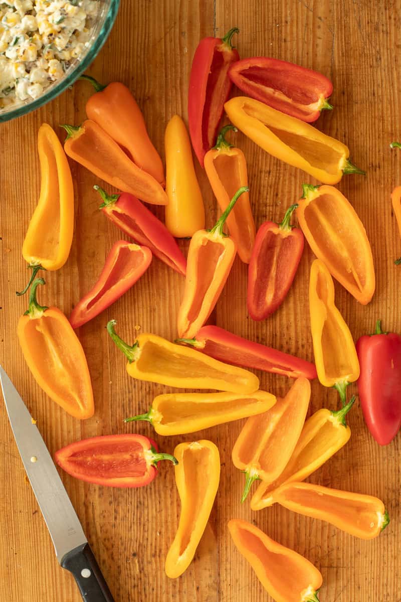 Multi-colored mini peppers cut in half and deseeded.