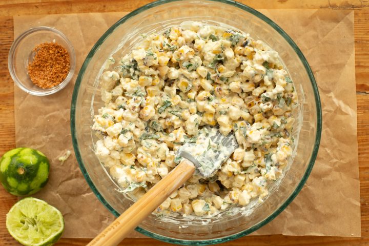 A glass bowl of Mexican street corn.